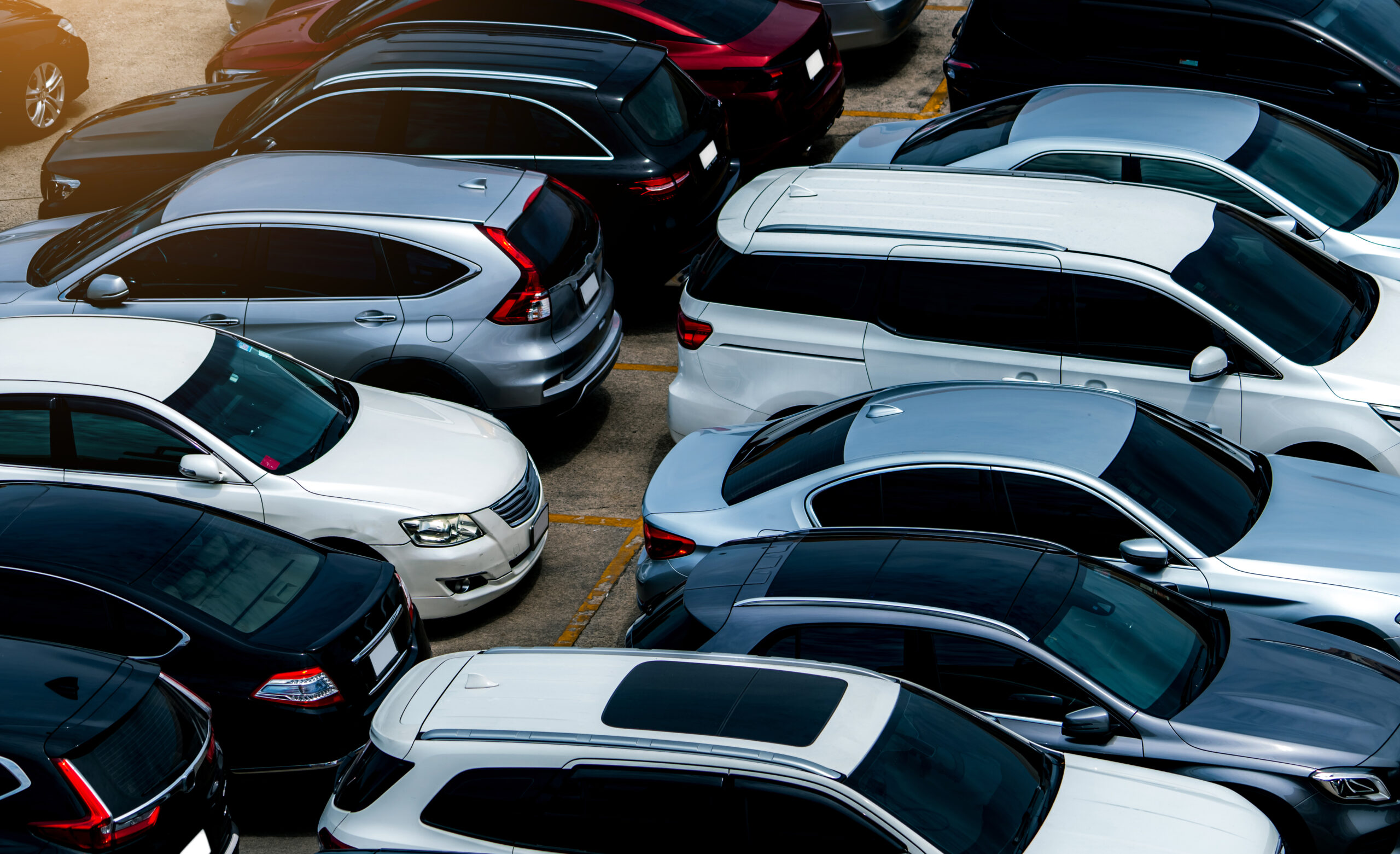 Aerial view of cars parked in parking lot.