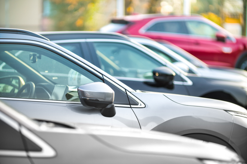 A line of parked cars from the side.
