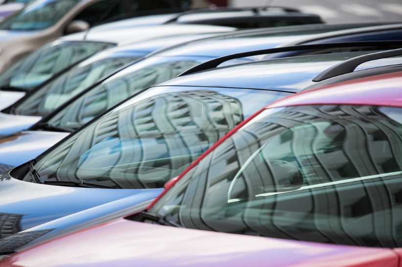 A line of cars with the cameras with the focus being their windshields.